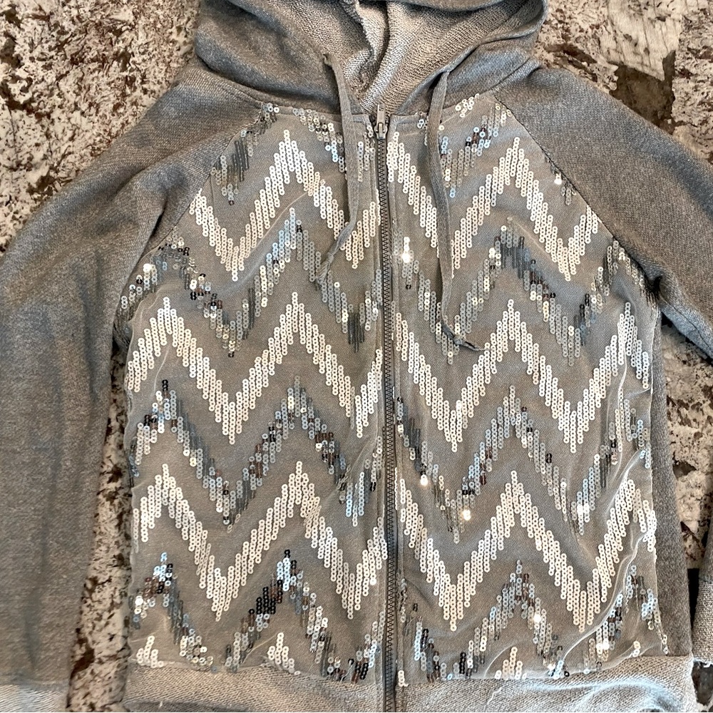 Zip-front hoodie embellished with sparkly sequin chevron pattern. Size M